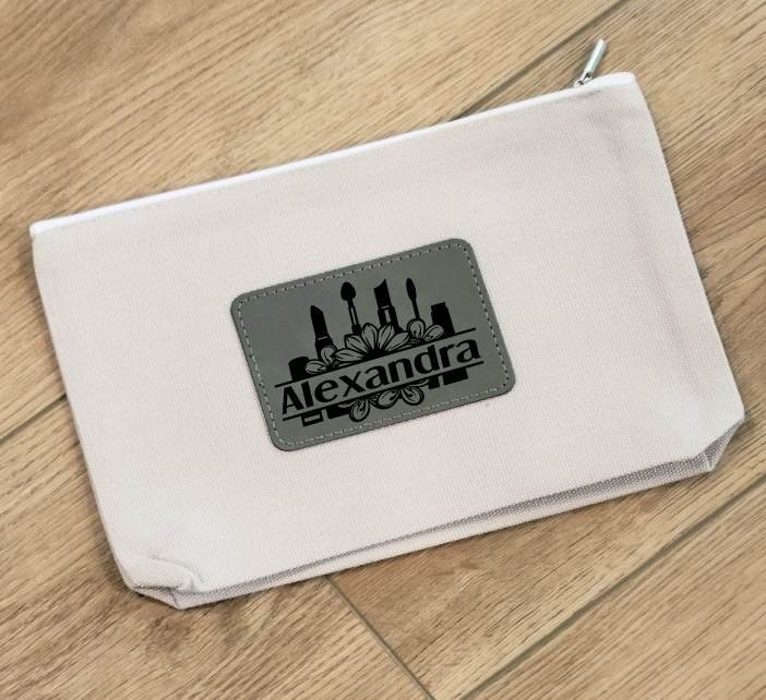 Personalized canvas cosmetic bag with leatherette patch, perfect for travel or everyday use.