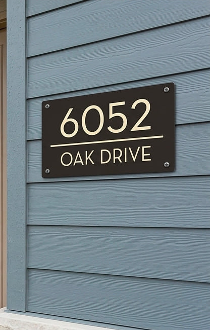 House number sign with '6052 Oak Drive' on a blue siding background