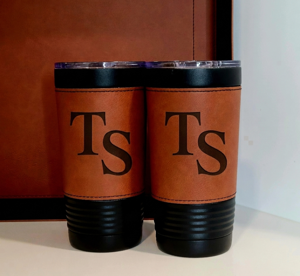 ​Noir Designed custom laser engraved 20oz insulated tumblers with cognac vegan leather wraps and personalized initials.
